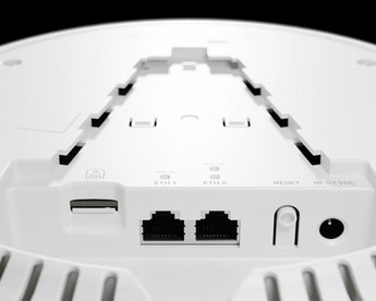 MikroTik cAP LTE12 ax: White, round ceiling access point with dual-band WiFi 6 and LTE connectivity for indoor use.