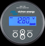 Victron BMV-700 battery monitor displaying voltage, current, and charge status on its LCD screen. Monitors 9-90VDC systems.
